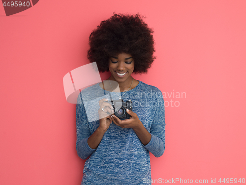 Image of young black girl taking photo on a retro camera