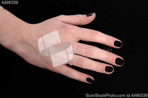 Image of The hand of a woman on black background