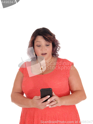 Image of Woman looking surprised at her cell phone