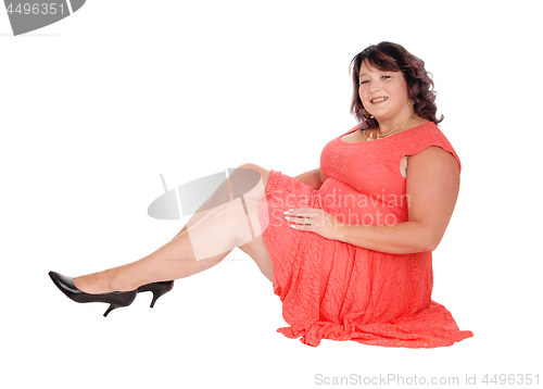 Image of Overweight woman sitting on floor