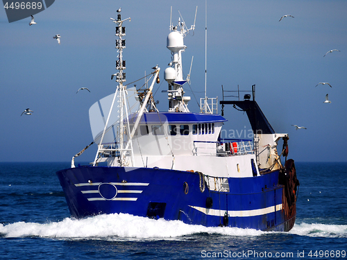 Image of Blue Fishing Boat at Speed.