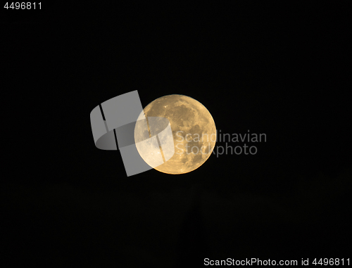 Image of Rising Cold Moon on Black Background