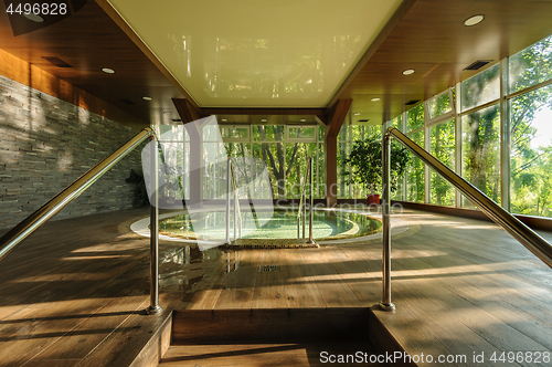Image of Big round jacuzzi bath in spa center, early morning