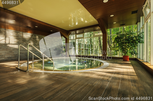 Image of Big round jacuzzi bath in spa center, early morning