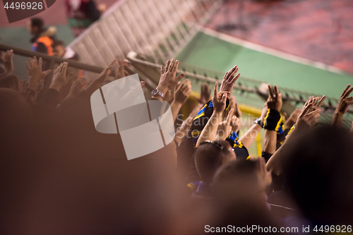 Image of soccer fans hands clapping while supporting their team