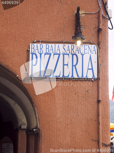 Image of editorial pizzeria restaurant sign on old building in Vernazza C