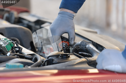 Image of engine oil changing at car with liquefied petroleum gas system