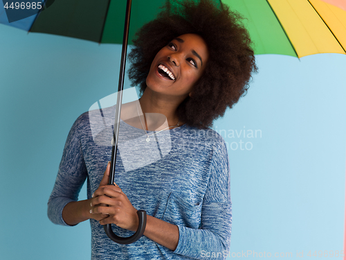 Image of beautiful black woman holding a colorful umbrella