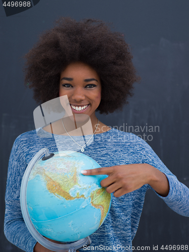 Image of black woman holding Globe of the world