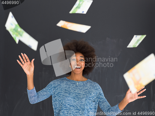 Image of black woman throwing money