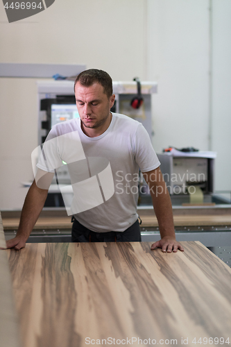 Image of worker in a factory of wooden furniture