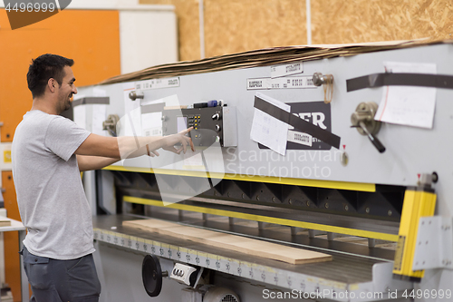 Image of worker in a factory of wooden furniture