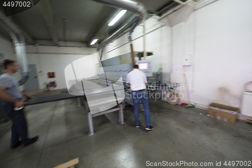 Image of workers in a factory of wooden furniture