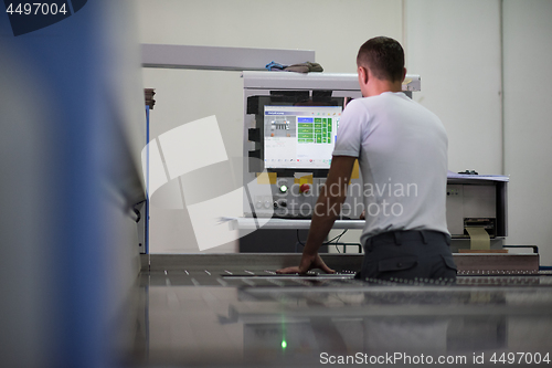 Image of worker in a factory of wooden furniture