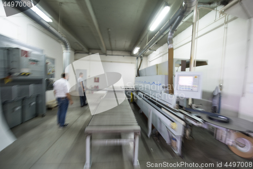 Image of workers in a factory of wooden furniture