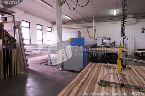 Image of worker in a factory of wooden furniture