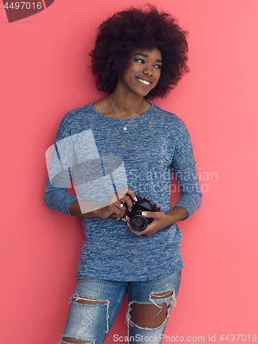 Image of young black girl taking photo on a retro camera