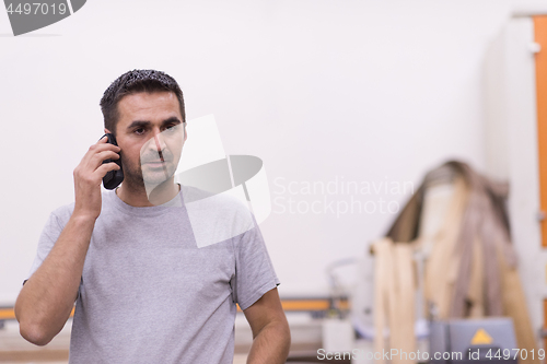 Image of engineer in front of wood cutting machine