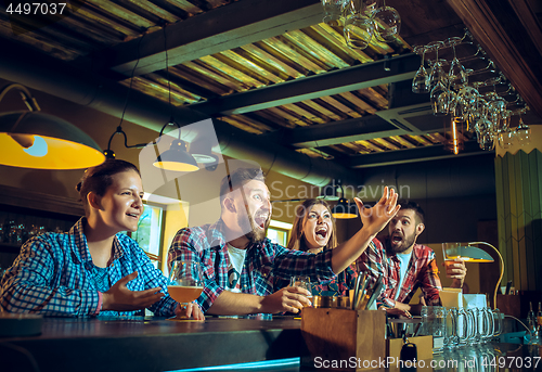 Image of Sport, people, leisure, friendship and entertainment concept - happy football fans or male friends drinking beer and celebrating victory at bar or pub