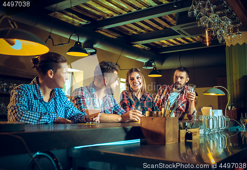 Image of Sport, people, leisure, friendship and entertainment concept - happy football fans or male friends drinking beer and celebrating victory at bar or pub