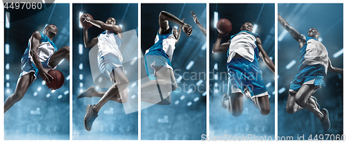 Image of Basketball player on big professional arena during the game. Basketball player making slam dunk.