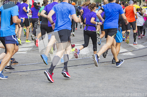 Image of Marathon runners running race people feet on city road 