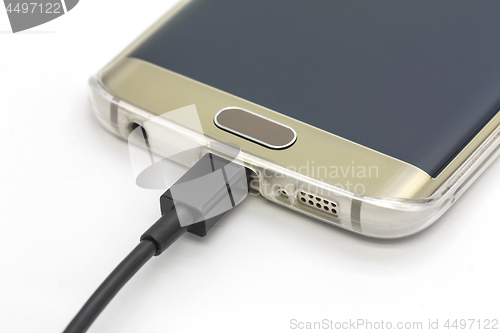 Image of Mobile smart phone charging on a white background