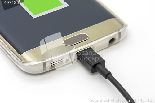 Image of Mobile smart phone charging on a white background