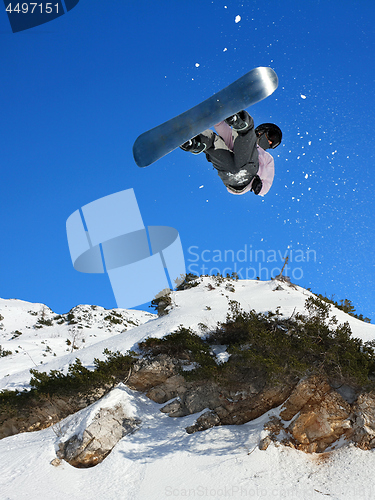 Image of Snowboarding Snowboard Snowboarder at jump mountains at sunny da