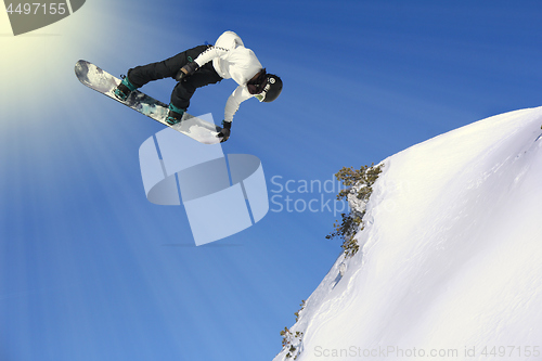 Image of Snowboarding Snowboard Snowboarder at jump mountains at sunny da