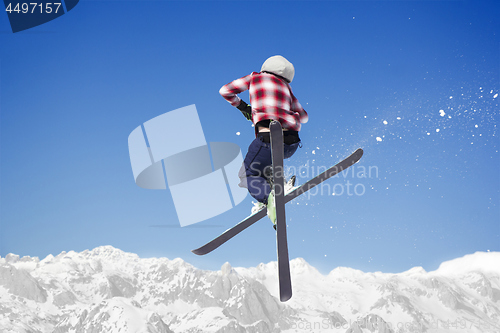 Image of Flying skier at jump inhigh on snowy mountains