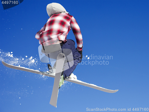 Image of Flying skier at jump inhigh on snowy mountains