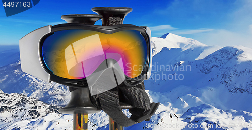 Image of Close up of the ski goggles through which it is seen snowed moun