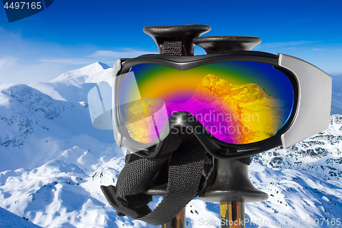 Image of Reflection of the snowy mountain Triglav in ski goggles on ski s