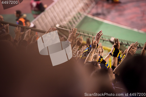 Image of soccer fans hands clapping while supporting their team