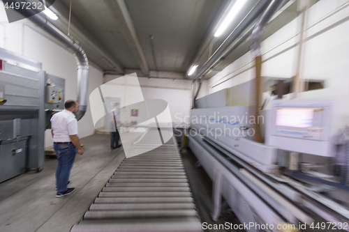 Image of workers in a factory of wooden furniture