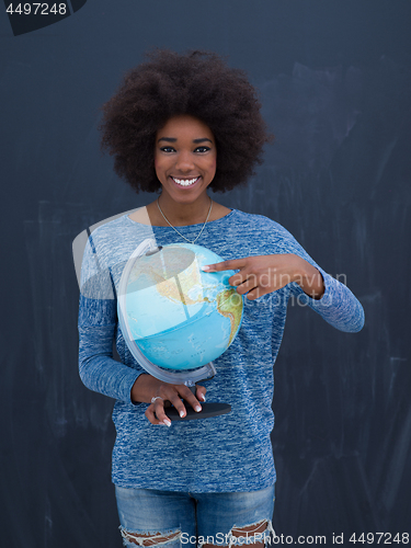 Image of black woman holding Globe of the world