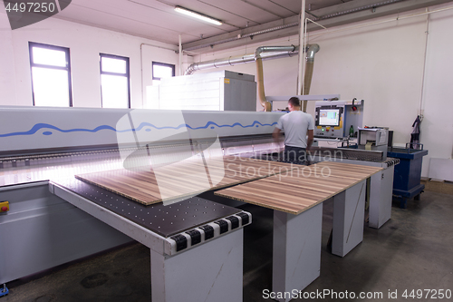 Image of worker in a factory of wooden furniture