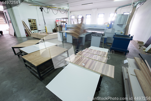 Image of worker in a factory of wooden furniture