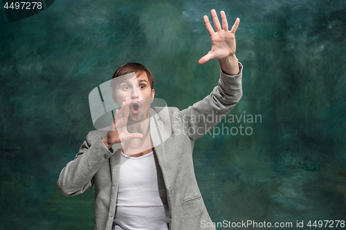 Image of Isolated on pink young casual man shouting at studio