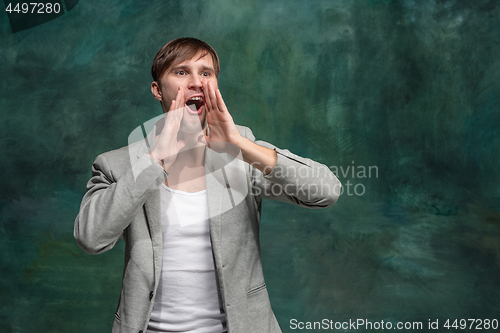 Image of Isolated on pink young casual man shouting at studio