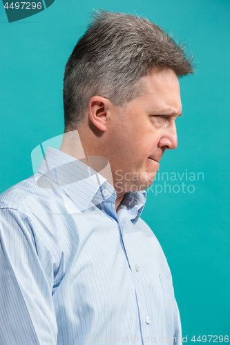 Image of The senior emotional angry man screaming on blue studio background