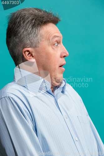 Image of The attractive man looking suprised isolated on blue