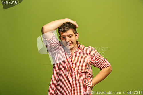 Image of Beautiful bored man isolated on green background