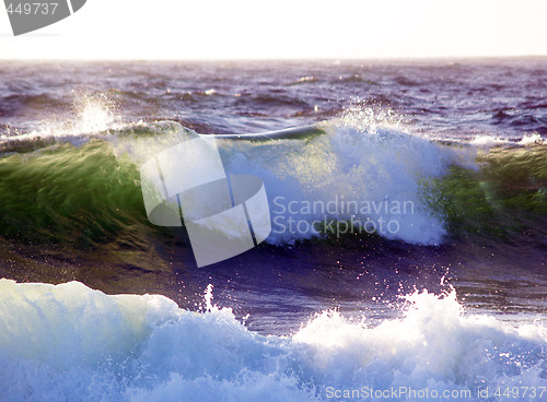 Image of Wave breaking with sunlight coming through from behind