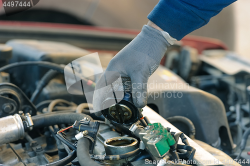 Image of engine oil changing at car with liquefied petroleum gas system