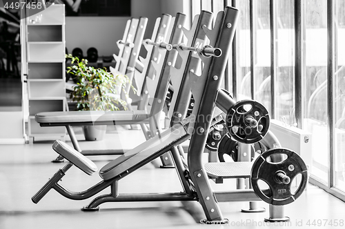 Image of Modern gym interior with bench press equipment in a raw