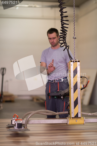 Image of worker in a factory of wooden furniture