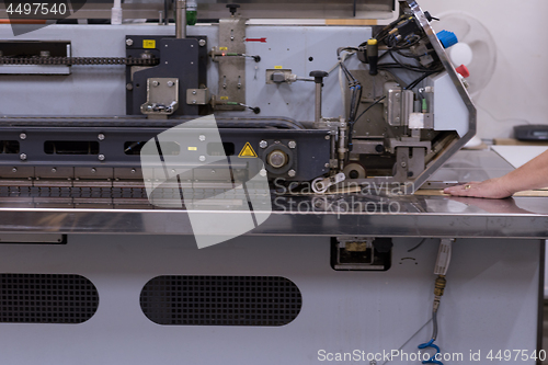 Image of engineer in front of wood cutting machine