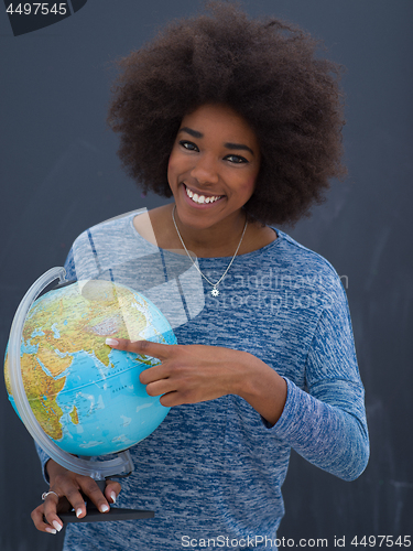 Image of black woman holding Globe of the world